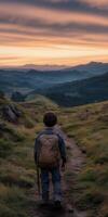 Child hiking on a trail at sunset in a mountainous landscape photo