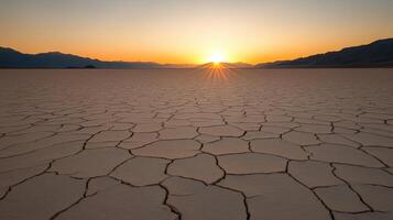 Sunset over the cracked desert landscape in Badwater Basin photo