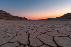 Vast cracked earth under twilight sky in arid landscape photo