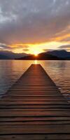 Sunset over the lake viewed from a wooden pier photo