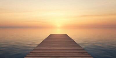 Sunset view from a wooden pier over calm water photo