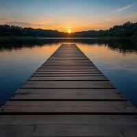 Sunset over tranquil lake with wooden dock extending photo