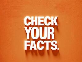 Bold Check Your Facts Message with Dynamic White Typography on Bright Orange Background. photo