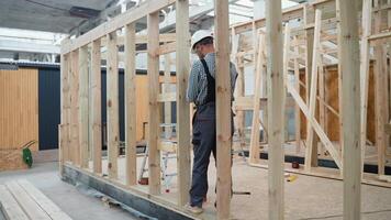 Worker carpenter assembling a modular house video