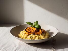 Delicious Creamy Saffron Risotto with Grilled Pumpkin and Basil. photo