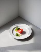 A plate of food with a tomato and lettuce on it photo