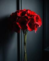Vibrant red flowers create a striking visual display in a dark setting photo