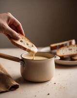 Delicious Fondue with Bread Dipping in Soft Focus photo