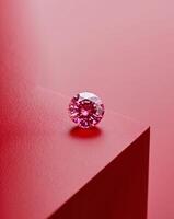 A pink diamond is sitting on a red surface photo