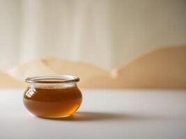 Glass Jar of Honey with Soft Light Background. photo
