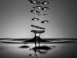 Macro view of water droplets falling onto a smooth surface. photo