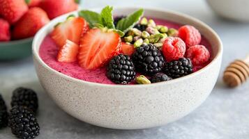 A colorful smoothie bowl topped with fresh berries and mint. photo