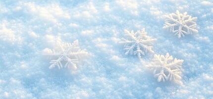 Snowflakes resting on a soft blanket of snow, creating a serene winter scene. photo
