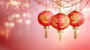 Three red lanterns with gold designs hanging from a tree photo