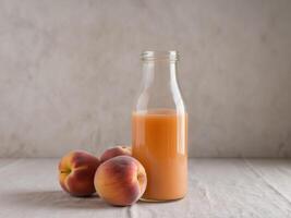 A bottle of peach juice next to a bunch of peaches. photo
