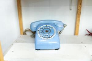 Old telephone on white background. Shallow depth of field. photo