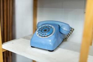 Old telephone on white background. Shallow depth of field. photo
