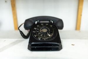 Old telephone on white background. Shallow depth of field. photo