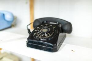 Old telephone on white background. Shallow depth of field. photo