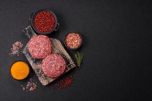 Fresh raw ground beef burger patty with salt and spices photo