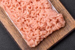 Raw minced chicken with salt, spices and herbs photo