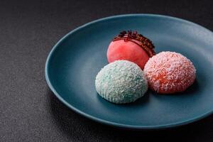 Delicious colorful asian mochi sweets with rice dough shell and fruit filling photo
