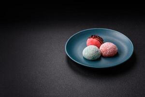 Delicious colorful asian mochi sweets with rice dough shell and fruit filling photo