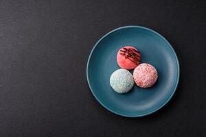 Delicious colorful asian mochi sweets with rice dough shell and fruit filling photo