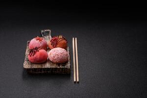 Delicious colorful asian mochi sweets with rice dough shell and fruit filling photo