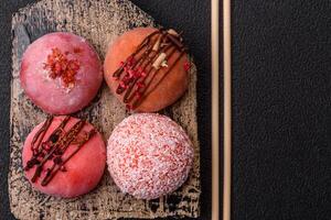 Delicious colorful asian mochi sweets with rice dough shell and fruit filling photo