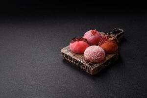 Delicious colorful asian mochi sweets with rice dough shell and fruit filling photo