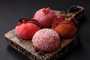 Delicious colorful asian mochi sweets with rice dough shell and fruit filling photo