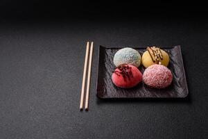 Delicious colorful asian mochi sweets with rice dough shell and fruit filling photo