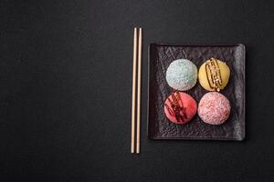 Delicious colorful asian mochi sweets with rice dough shell and fruit filling photo