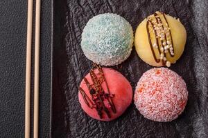 Delicious colorful asian mochi sweets with rice dough shell and fruit filling photo