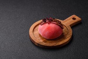 Delicious colorful asian mochi sweets with rice dough shell and fruit filling photo