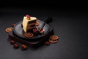 Piece of sweet layered cheesecake with cherries and poppy seeds photo