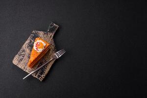 Piece of sweet layer cake with pumpkin or citrus flavor with cream photo