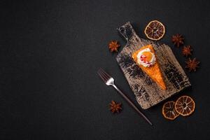 Piece of sweet layer cake with pumpkin or citrus flavor with cream photo