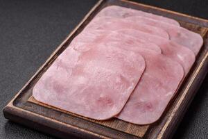 Boiled ham cut into square slices with sorrel and spices photo