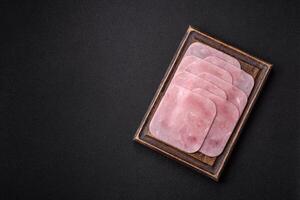 Boiled ham cut into square slices with sorrel and spices photo