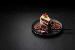 Piece of sweet layered cheesecake with cherries and poppy seeds photo