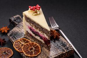 Piece of sweet layered cheesecake with cherries and poppy seeds photo