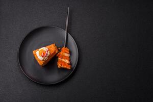Piece of sweet layer cake with pumpkin or citrus flavor with cream photo