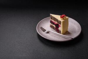 Piece of sweet layered cheesecake with cherries and poppy seeds photo