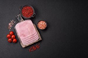 Boiled ham cut into square slices with sorrel and spices photo