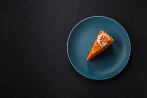 Piece of sweet layer cake with pumpkin or citrus flavor with cream photo