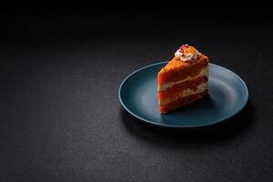 Piece of sweet layer cake with pumpkin or citrus flavor with cream photo
