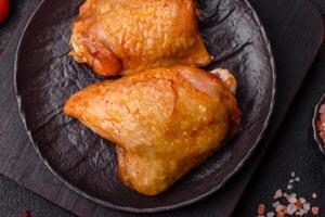 Chicken thighs fried with salt, spices and herbs photo