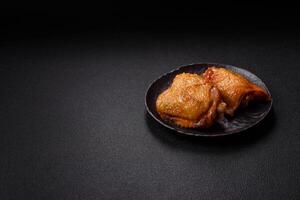 Chicken thighs fried with salt, spices and herbs photo